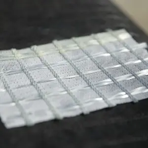 Warp knitted composite geotextiles prevent pavement cracks